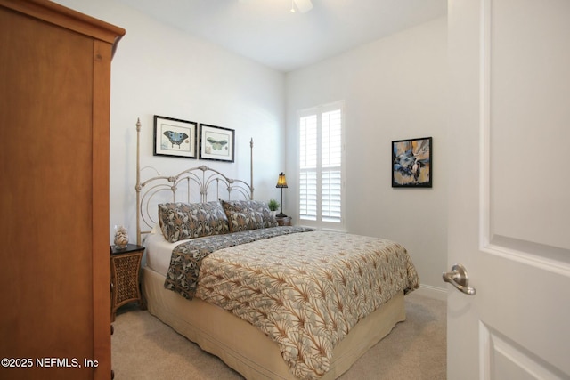 bedroom featuring light carpet and ceiling fan