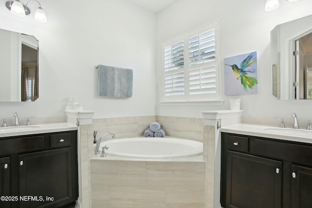 bathroom with vanity and tiled tub