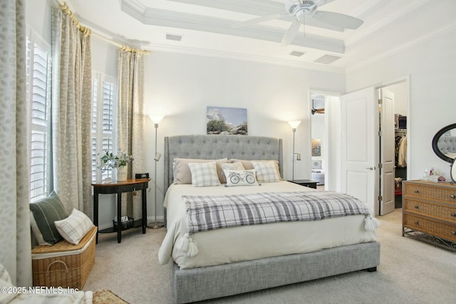 bedroom with light carpet, a walk in closet, ornamental molding, and ceiling fan