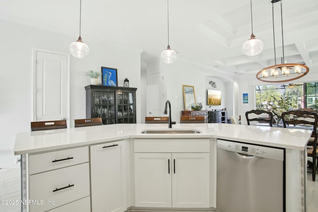 kitchen with coffered ceiling, sink, white cabinetry, decorative light fixtures, and stainless steel dishwasher