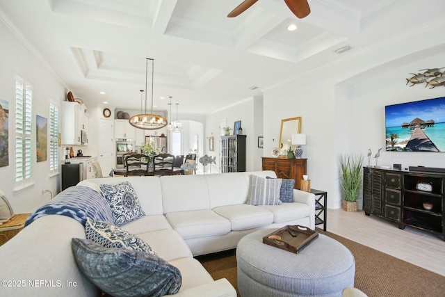 living room with beamed ceiling, crown molding, coffered ceiling, and a wealth of natural light