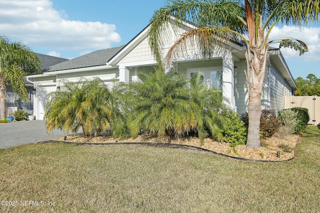 view of front of home with a garage and a front lawn