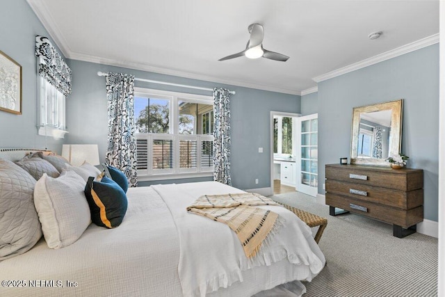 carpeted bedroom with crown molding, ensuite bath, and ceiling fan