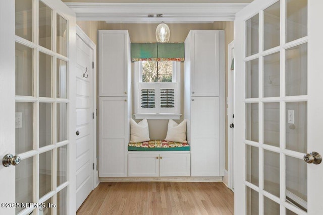 mudroom with light hardwood / wood-style floors and french doors