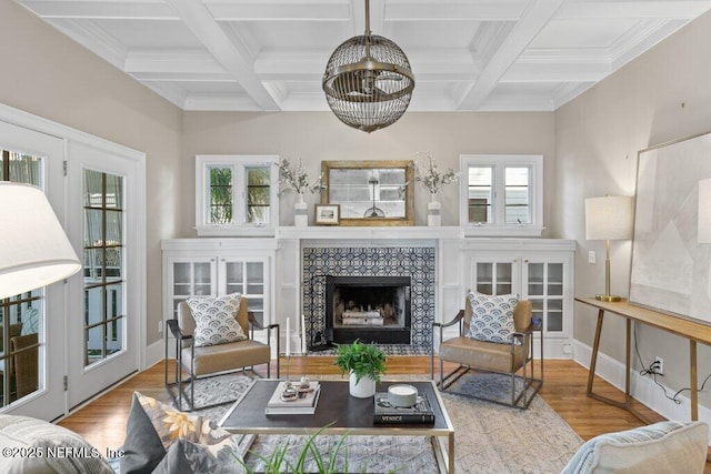 living room with coffered ceiling, beam ceiling, light hardwood / wood-style flooring, and a tile fireplace