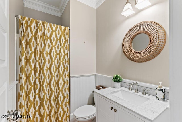 bathroom with crown molding, vanity, and toilet