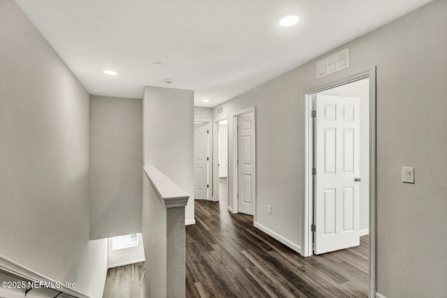 corridor with dark hardwood / wood-style flooring