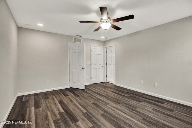 unfurnished bedroom featuring dark hardwood / wood-style flooring and ceiling fan