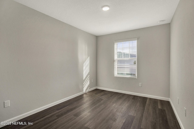 unfurnished room with dark hardwood / wood-style floors