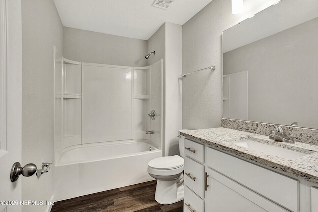 full bathroom featuring wood-type flooring, toilet, shower / bath combination, and vanity