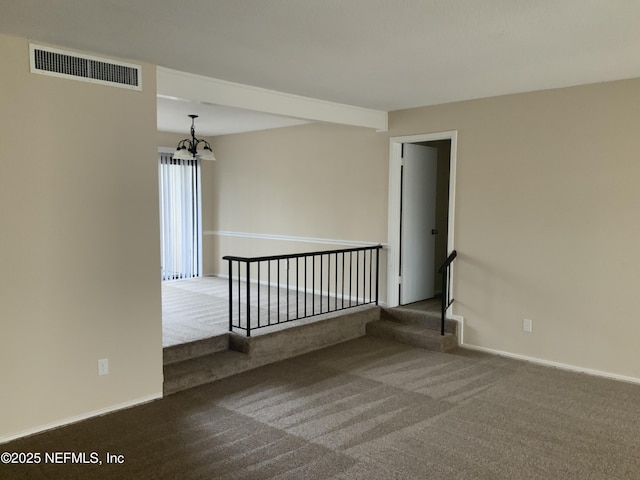 unfurnished room featuring carpet and a notable chandelier