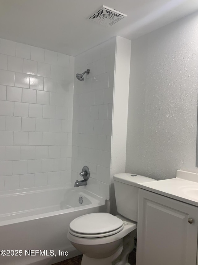 full bathroom with vanity, toilet, and tiled shower / bath combo