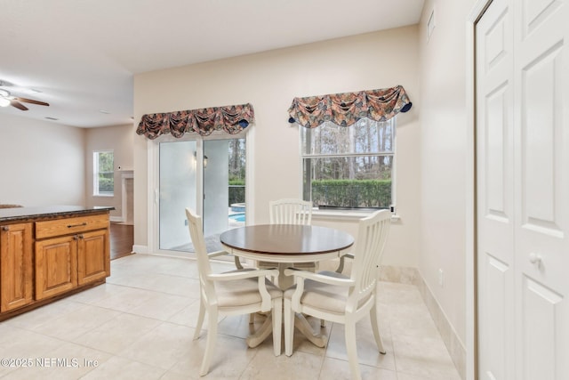 tiled dining area featuring ceiling fan