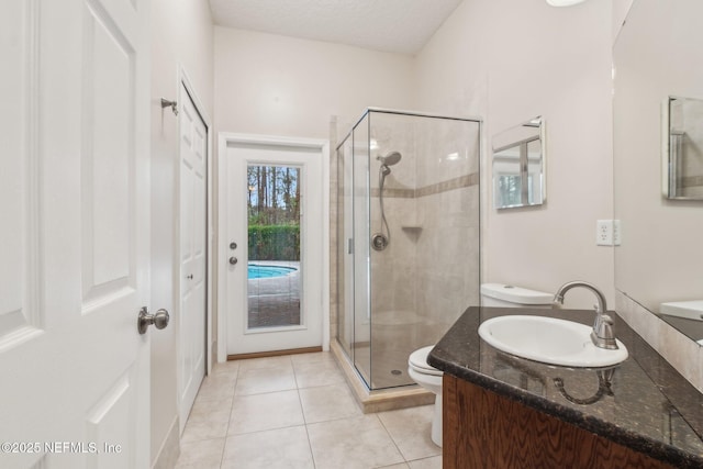 bathroom with tile patterned flooring, vanity, an enclosed shower, and a textured ceiling