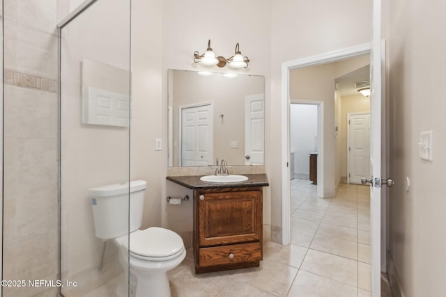 bathroom featuring vanity, toilet, and tile patterned flooring