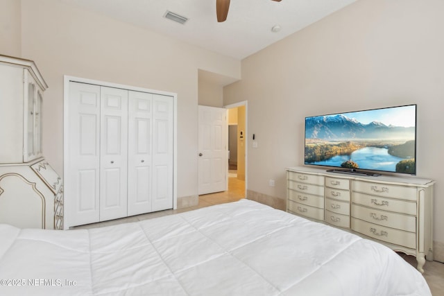 tiled bedroom featuring ceiling fan and a closet