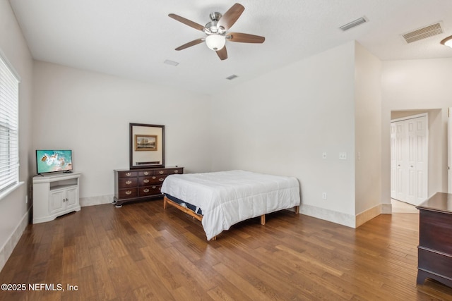 bedroom with ceiling fan and dark hardwood / wood-style flooring