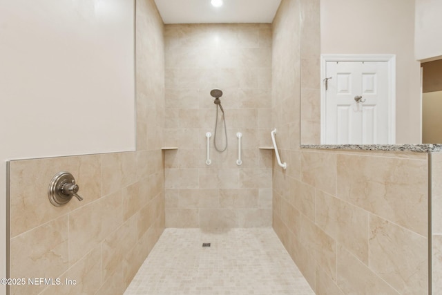 bathroom with a tile shower