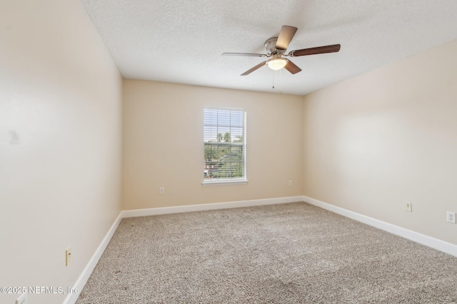 spare room featuring ceiling fan, carpet flooring, and a textured ceiling