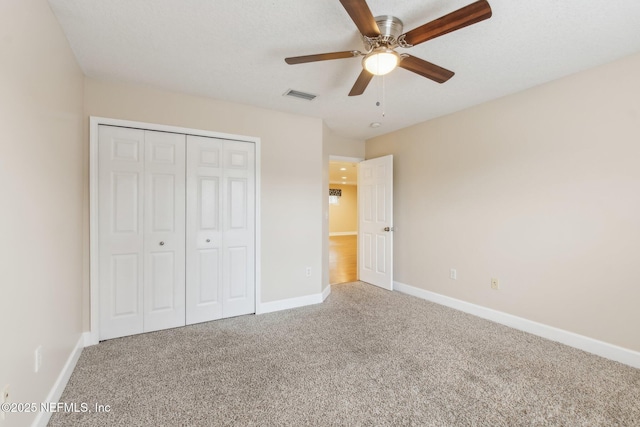 unfurnished bedroom with a closet, ceiling fan, and carpet flooring