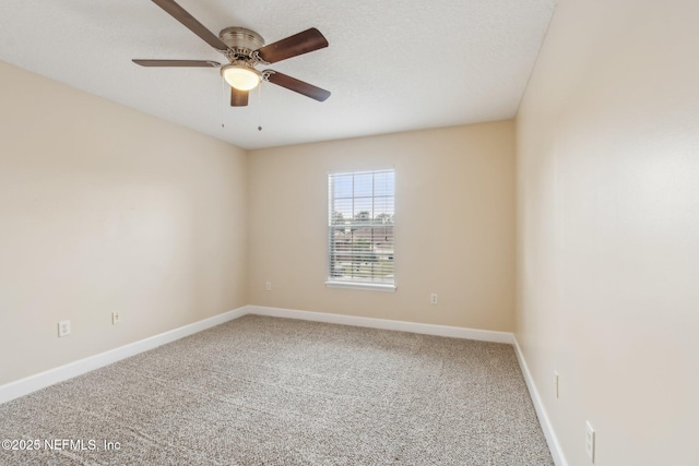 empty room with ceiling fan, carpet flooring, and a textured ceiling