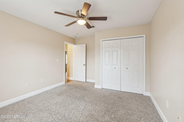 unfurnished bedroom with carpet flooring, ceiling fan, and a closet