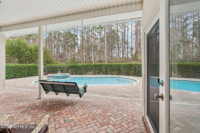 view of swimming pool with a patio and an in ground hot tub