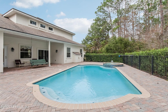 view of swimming pool with an in ground hot tub and a patio area