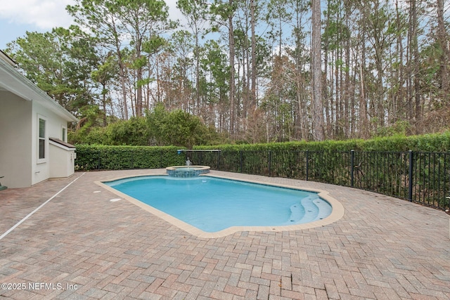 view of pool featuring a patio and an in ground hot tub