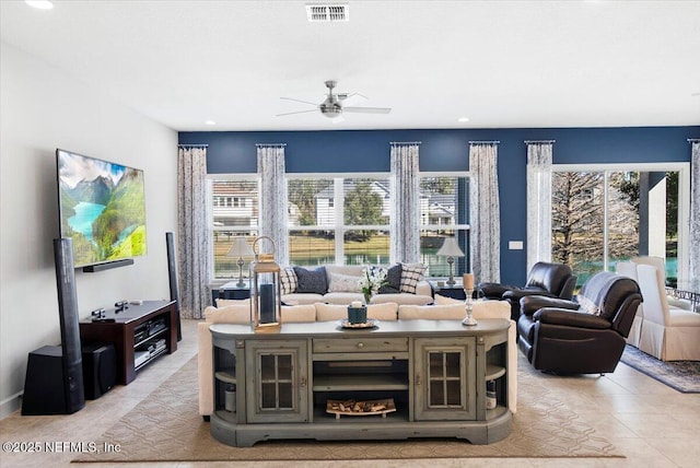 living room with ceiling fan and light tile patterned floors