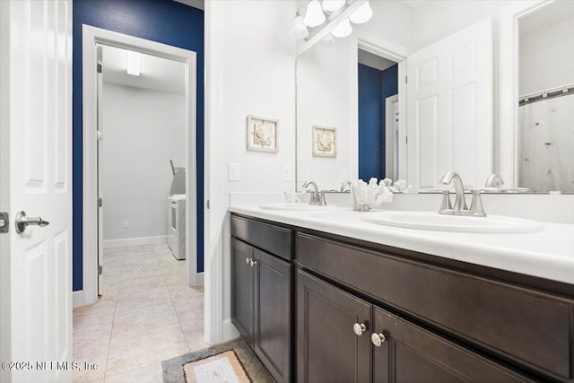 bathroom featuring washer / clothes dryer, vanity, and tile patterned floors