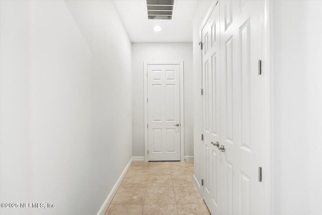 hall with light tile patterned floors