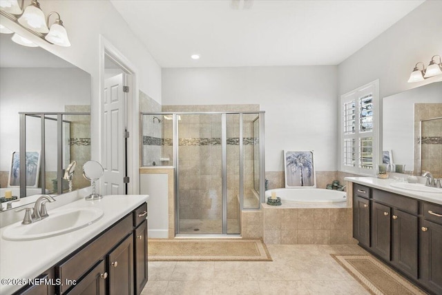 bathroom featuring independent shower and bath, vanity, and tile patterned flooring