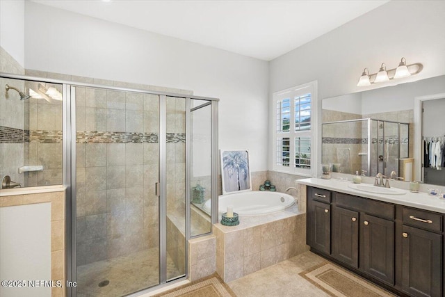 bathroom featuring tile patterned floors, vanity, and shower with separate bathtub