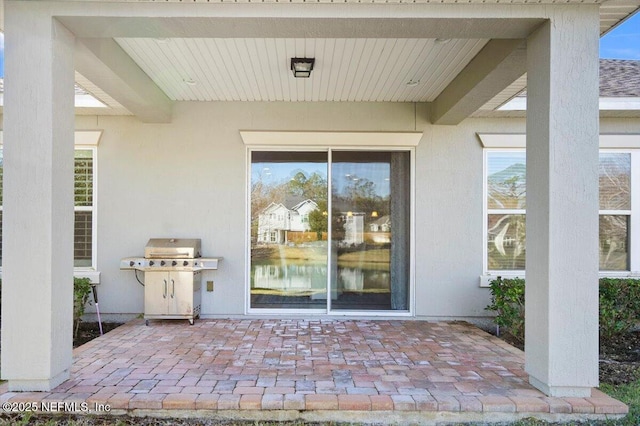 view of exterior entry featuring a patio