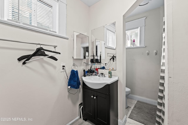 bathroom featuring vanity and toilet