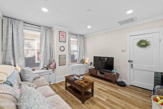 living room featuring light hardwood / wood-style flooring and a healthy amount of sunlight