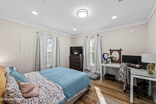 bedroom with hardwood / wood-style flooring and crown molding