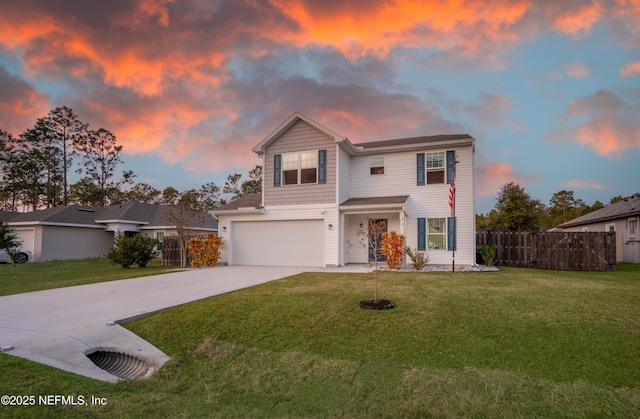 front facade featuring a garage and a lawn