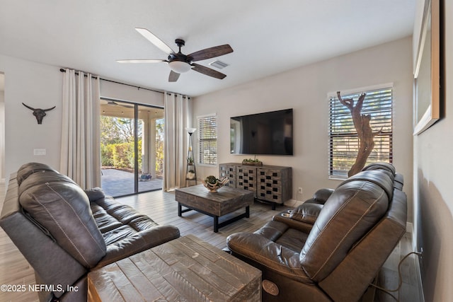 living room with hardwood / wood-style flooring and ceiling fan