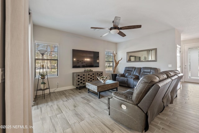 living room with a wealth of natural light and ceiling fan