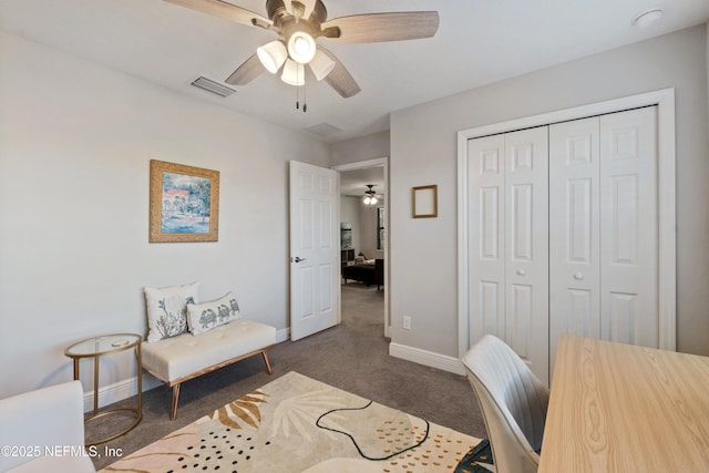 carpeted office space featuring ceiling fan