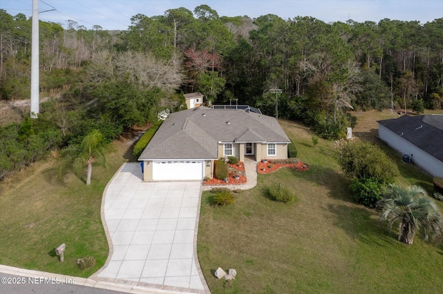 birds eye view of property featuring a view of trees