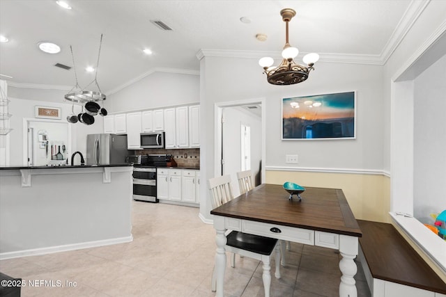 kitchen featuring decorative light fixtures, dark countertops, visible vents, appliances with stainless steel finishes, and white cabinets