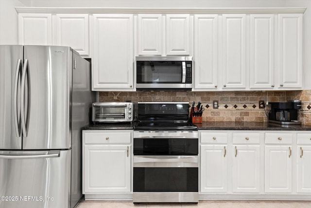 kitchen featuring appliances with stainless steel finishes, white cabinets, and decorative backsplash