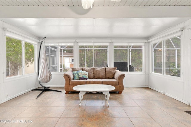 sunroom / solarium featuring beam ceiling