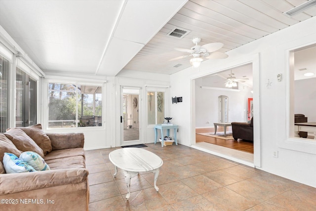 sunroom / solarium with visible vents and a ceiling fan