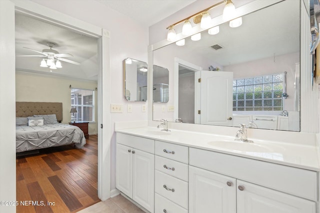 full bathroom with wood finished floors, ensuite bath, a sink, and visible vents