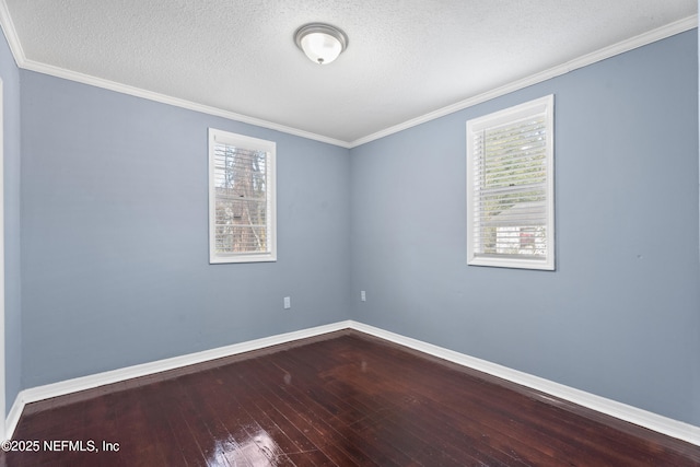 spare room featuring crown molding, wood-type flooring, and a textured ceiling