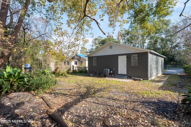 rear view of property with central AC